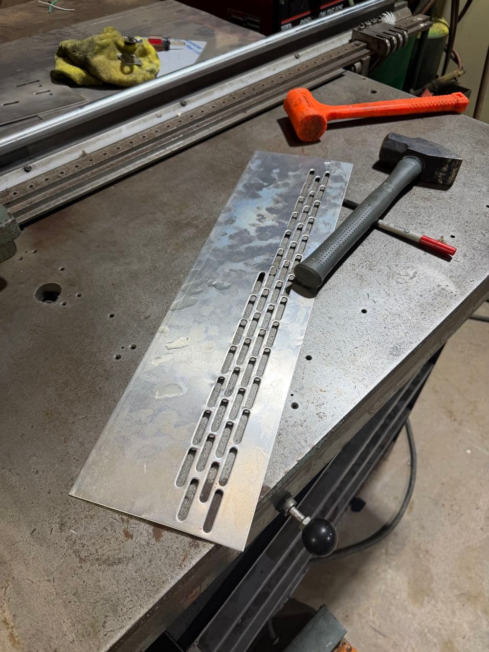 Metalwork table with a precision machined aluminum plate and tools for fabrication.